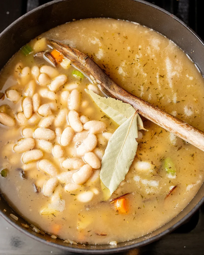 Add beans and bay leaves
