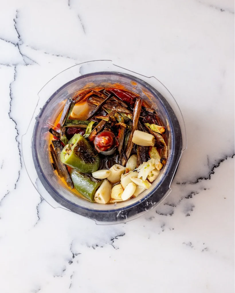 Add roasted aromatics to food processor