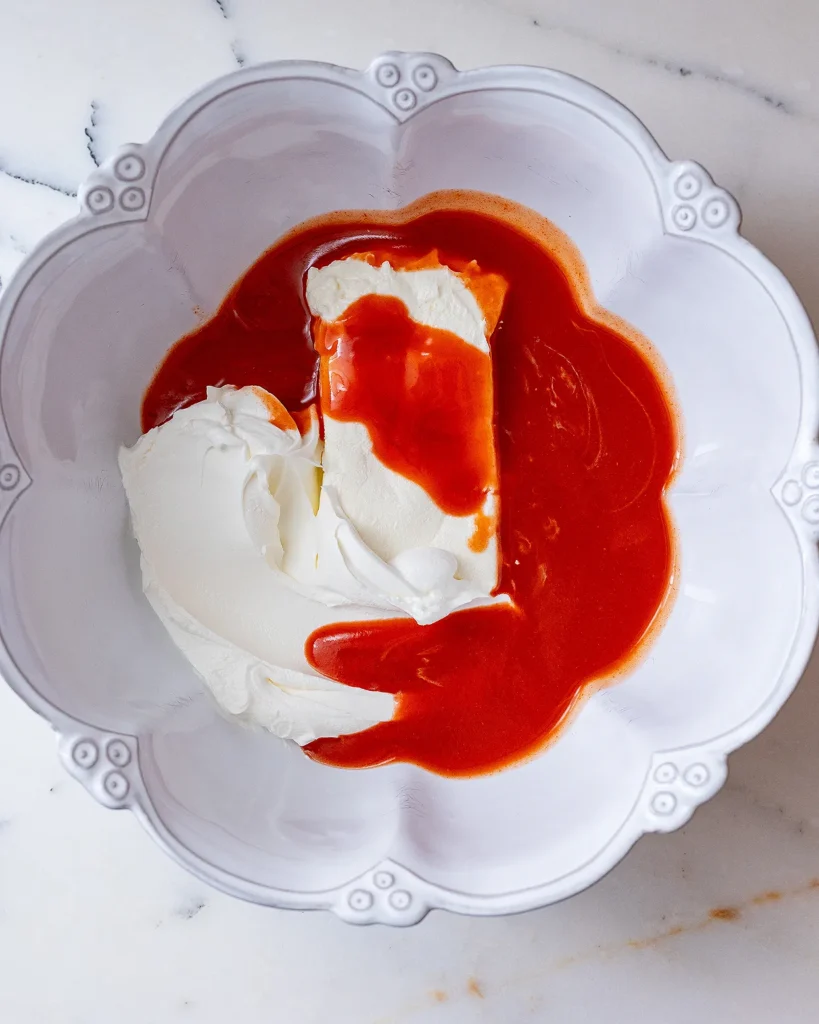 Combine Frank's hot sauce cream cheese and sour cream