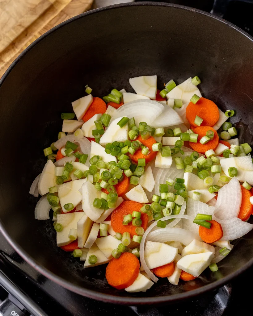 Saute carrots parsnips onion and scallion whites