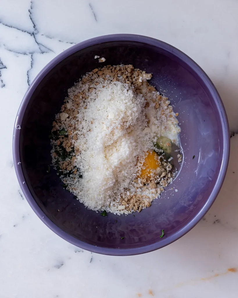 Add Parmesan cheese to meatball mixture