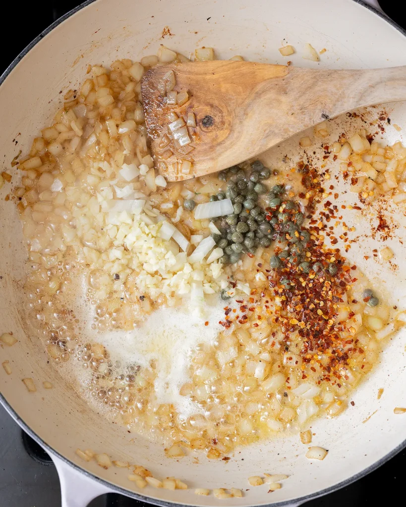 Add capers and crushed red pepper
