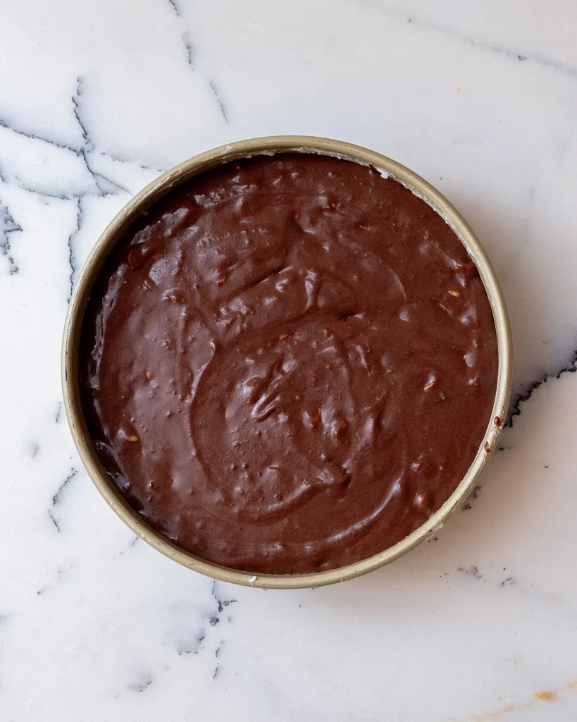 Add chocolate cake batter to cake pan
