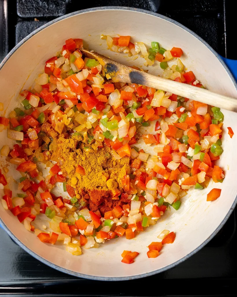 Add turmeric powder and Kashmiri chili powder