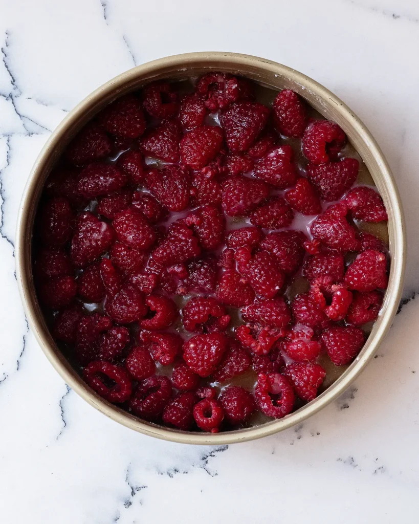 Pour raspberries into cake pan