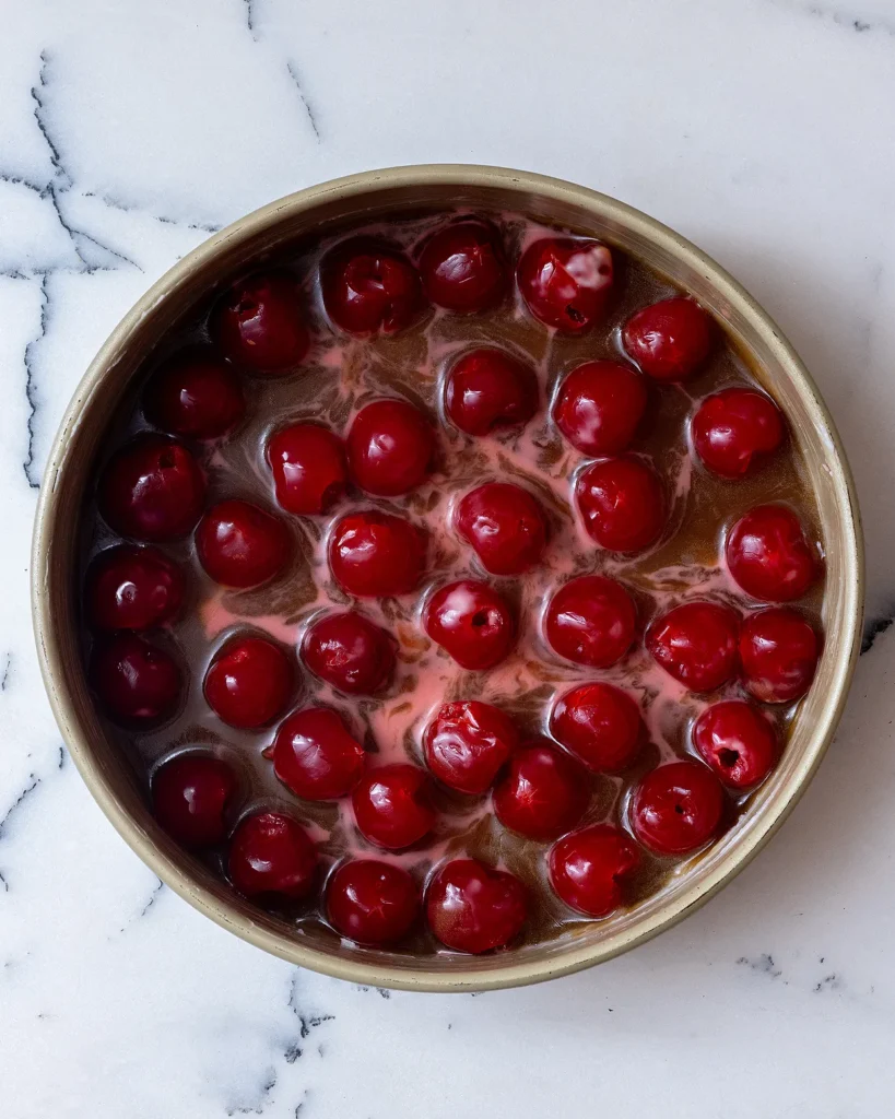 Add cherries to cake pan