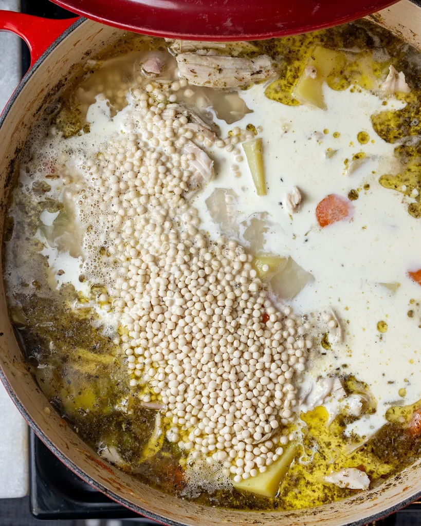 Add pearl couscous and heavy cream