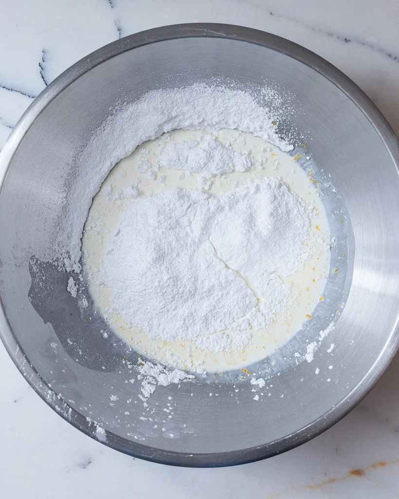 Add powdered sugar to heavy cream