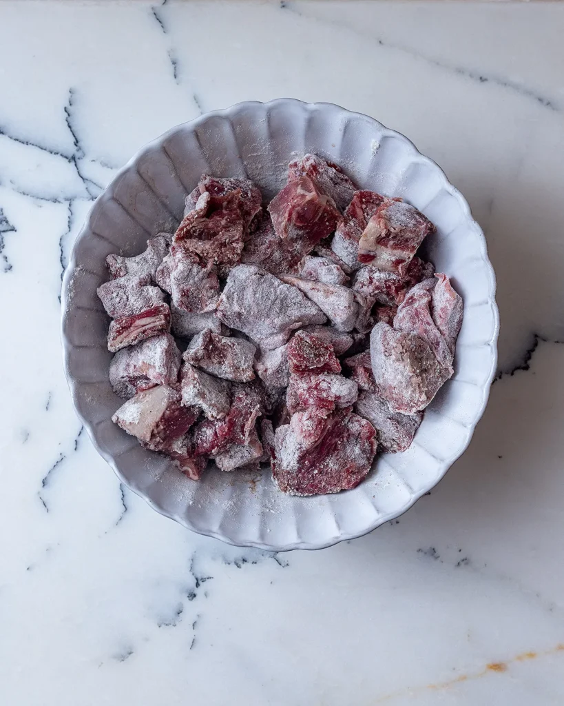 Coat beef in flour