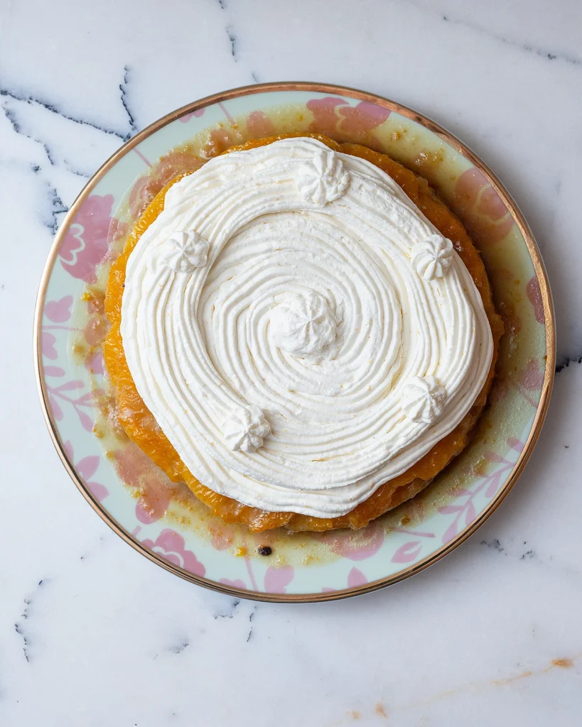 Frost the orange upside down cake