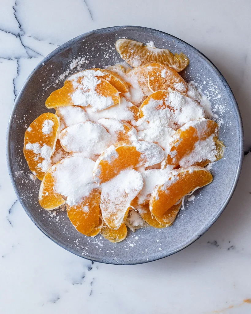 Oranges coated in sugar and cornstarch