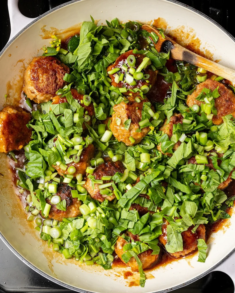 Add chopped yu choy to meatballs