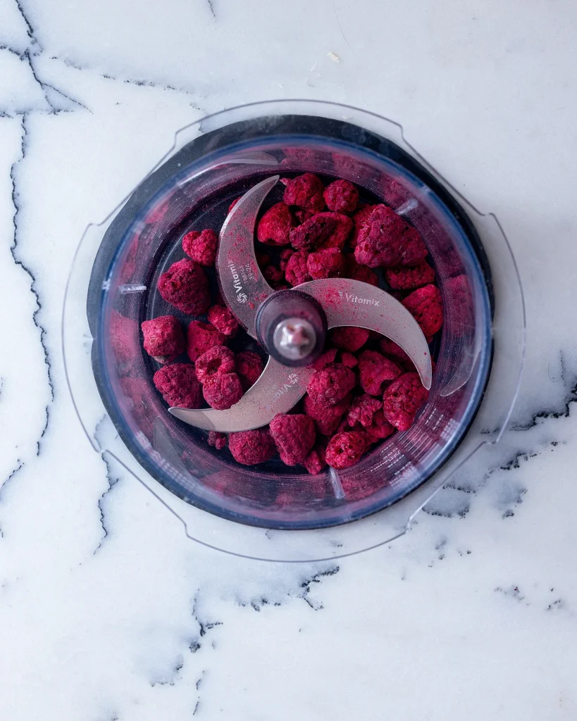 Add freeze dried raspberries to food processor