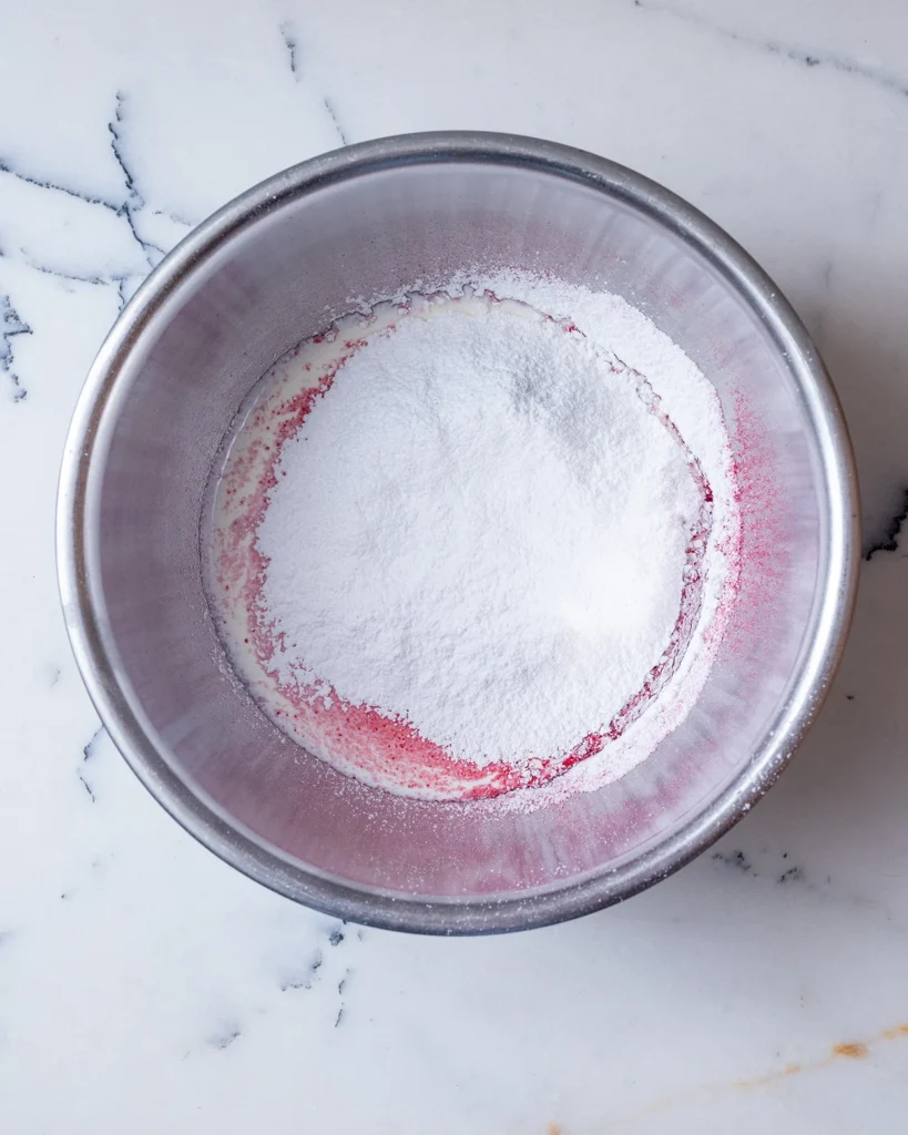 Add powdered sugar to whipped cream