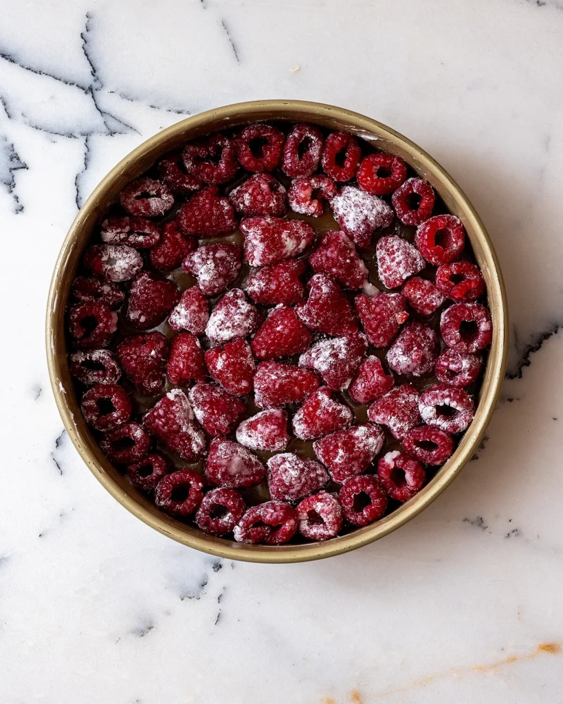 Arrange raspberries in cake pan
