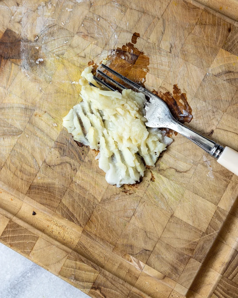 Mash cooked garlic