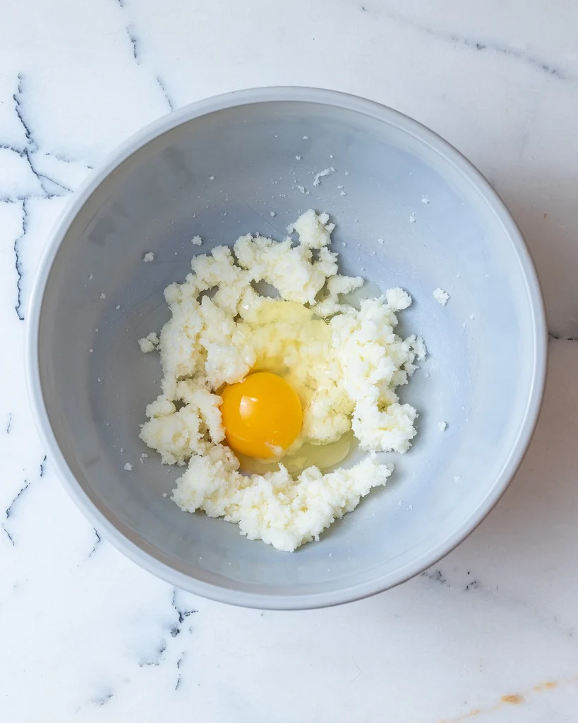 Add egg to butter and sugar