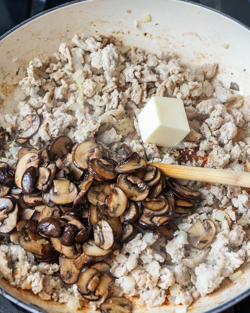 Add cooked mushrooms and butter to chicken
