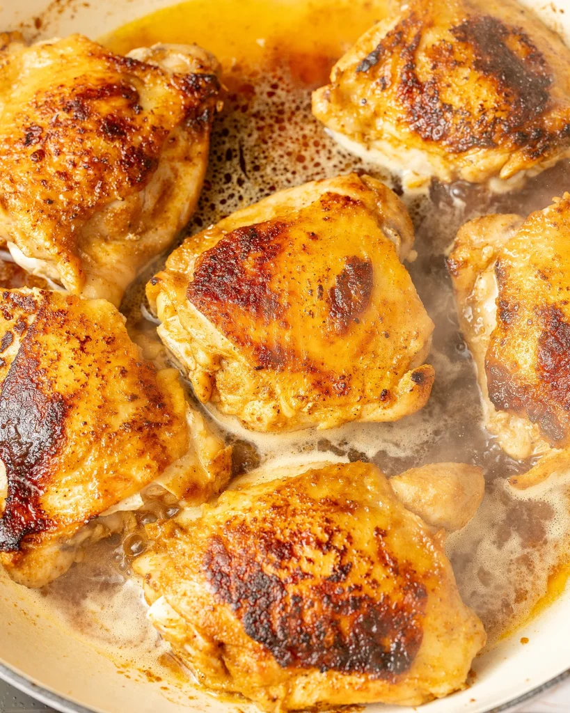 Browned chicken thighs with water