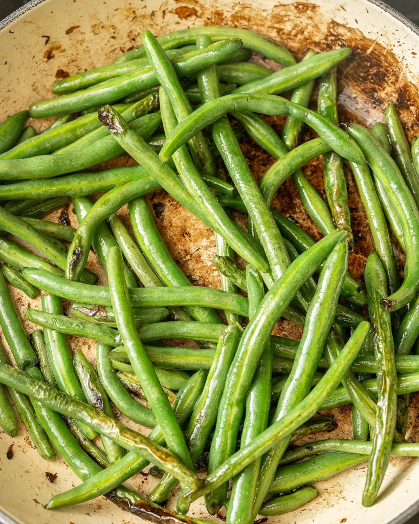 Saute green beans until blistered