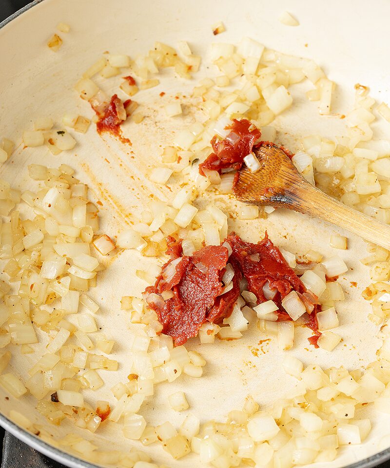 Add tomato paste and garlic