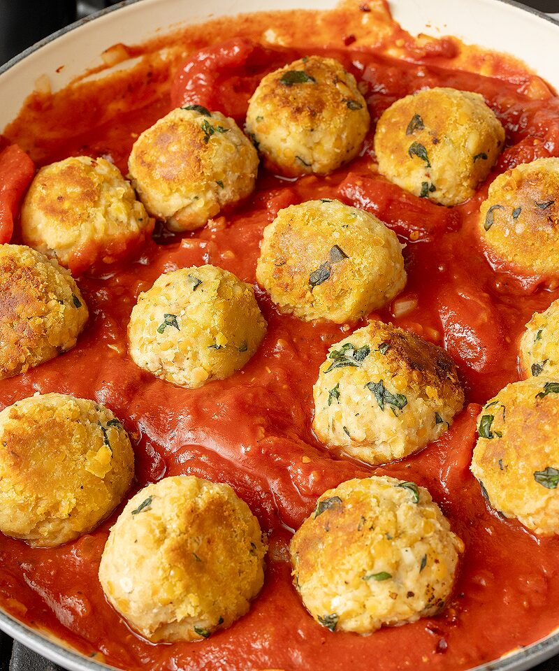 Simmer red lentil balls in red sauce