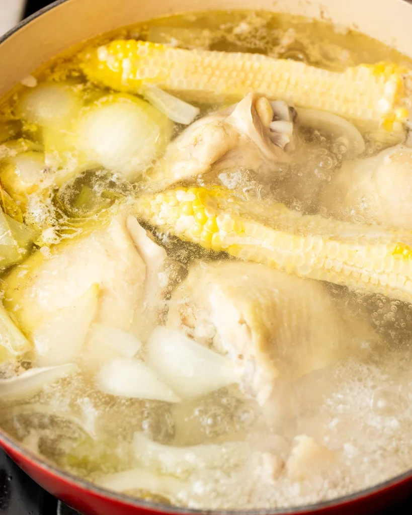 Add corn cobs to chicken broth