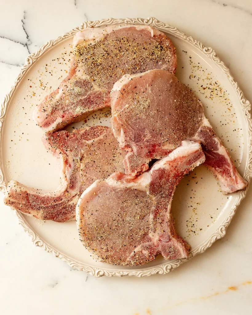 Season lemon pepper pork chops